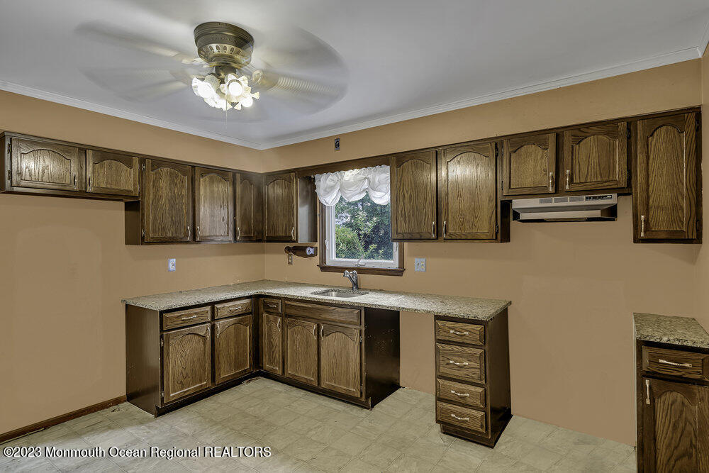 10 Eagle Drive Bayville, NJ 08721 - Photo 25 of 42 a kitchen with stainless steel appliances granite countertop a sink and cabinets