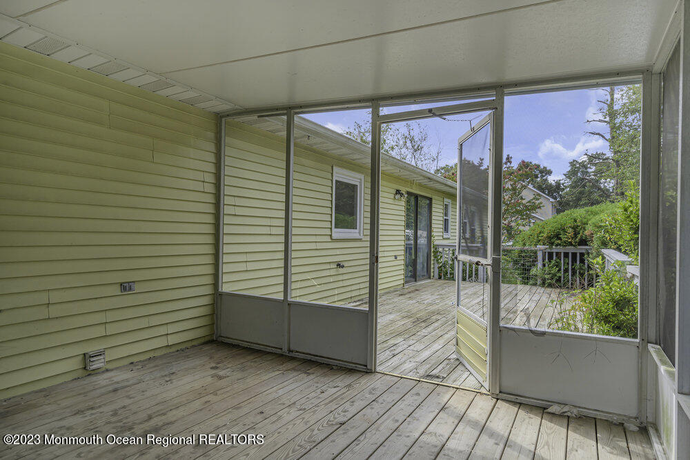 10 Eagle Drive Bayville, NJ 08721 - Photo 41 of 42 a view of a porch with wooden floor and iron stairs
