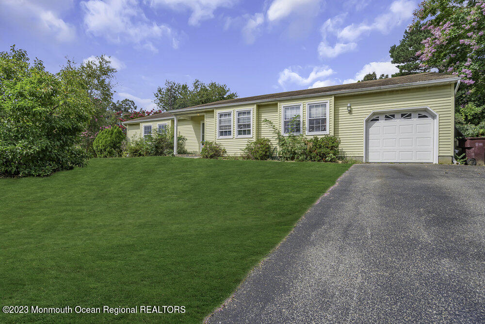 10 Eagle Drive Bayville, NJ 08721 - Photo 5 of 42 a front view of a house with a yard and garage