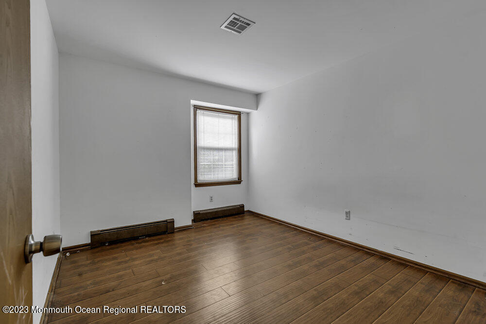 10 Eagle Drive Bayville, NJ 08721 - Photo 10 of 42 an empty room with wooden floor and windows