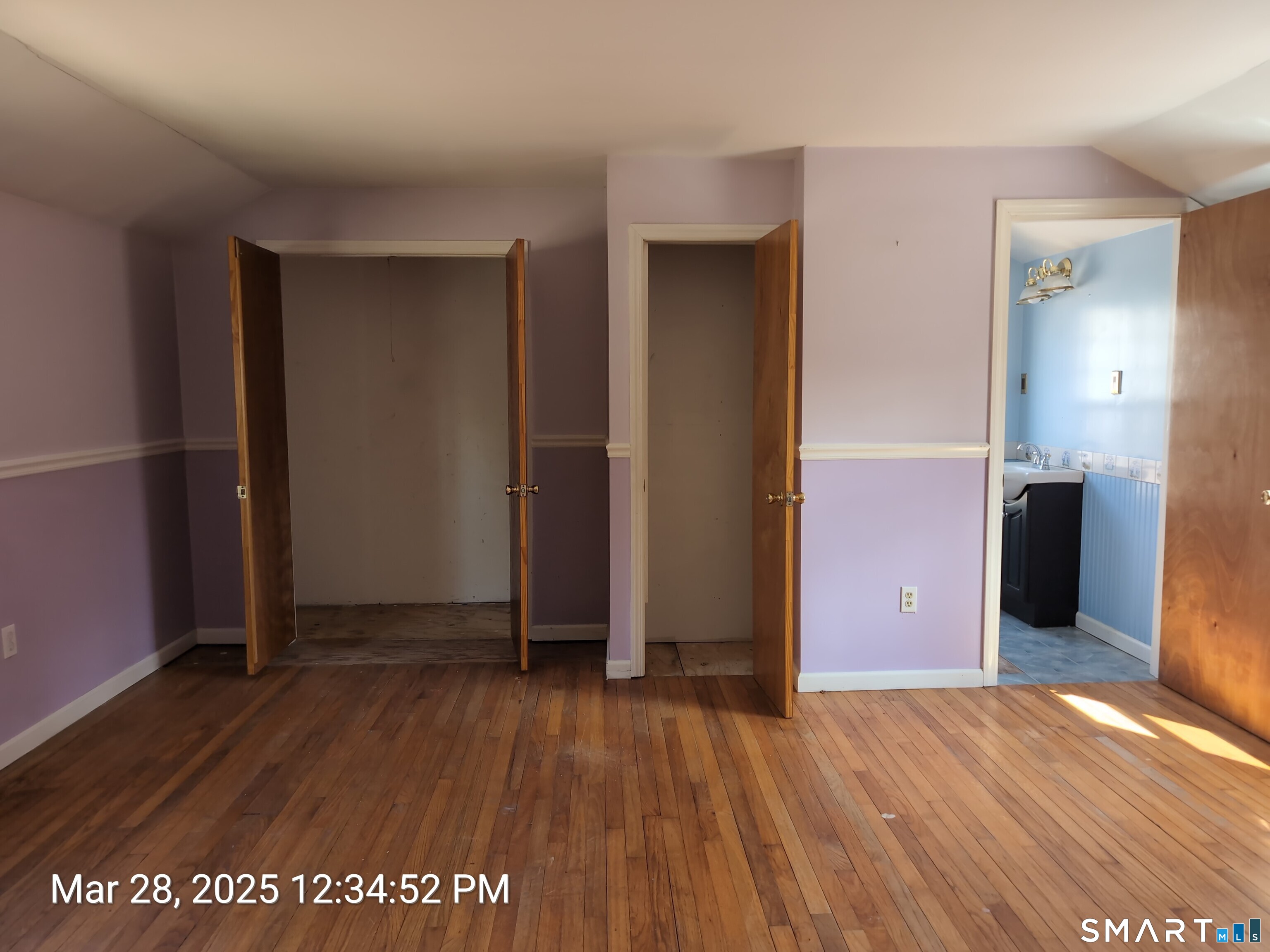 97 Bushy Hill Road Deep River, CT 06417 - Photo 24 of 28 an empty room with wooden floor and windows