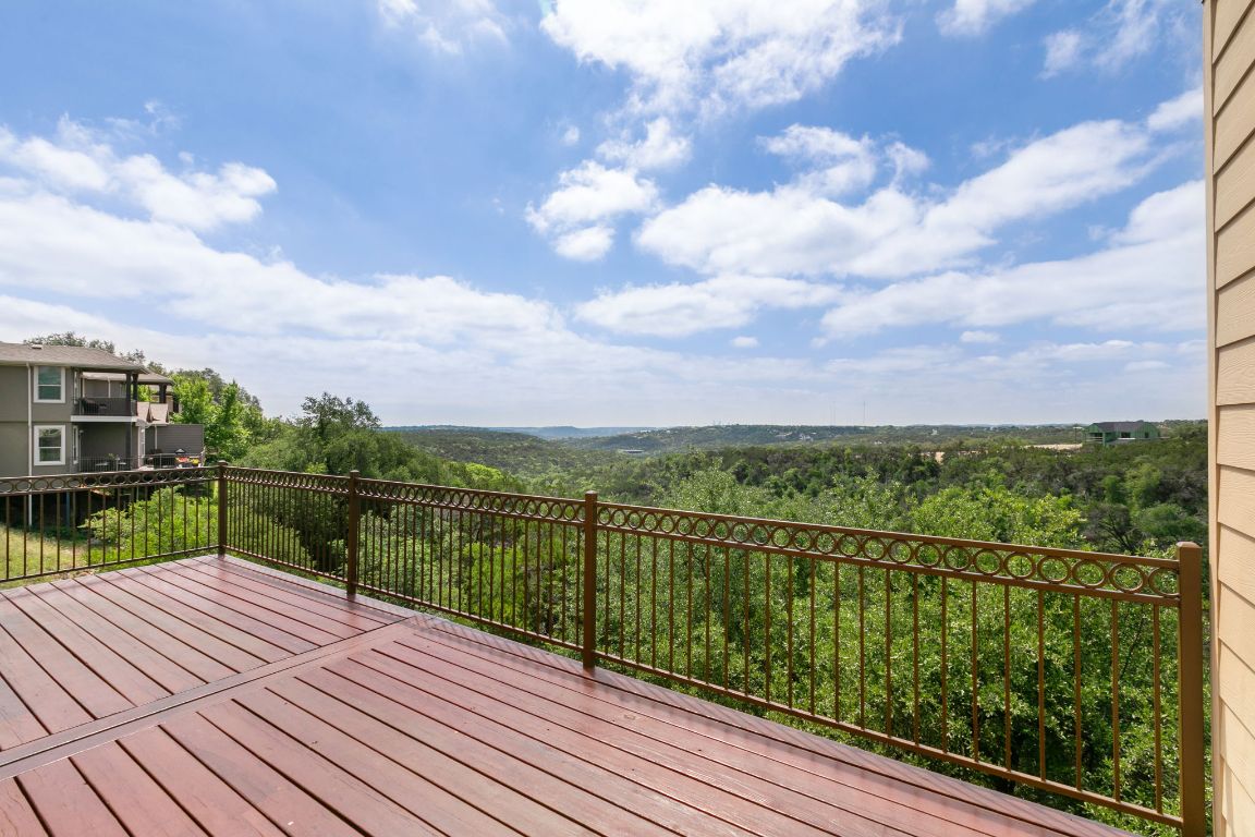 9617 Solana Vista Loop, Unit A Austin, TX 78750 - Photo 2 of 35 a view of a balcony with wooden floor & fence