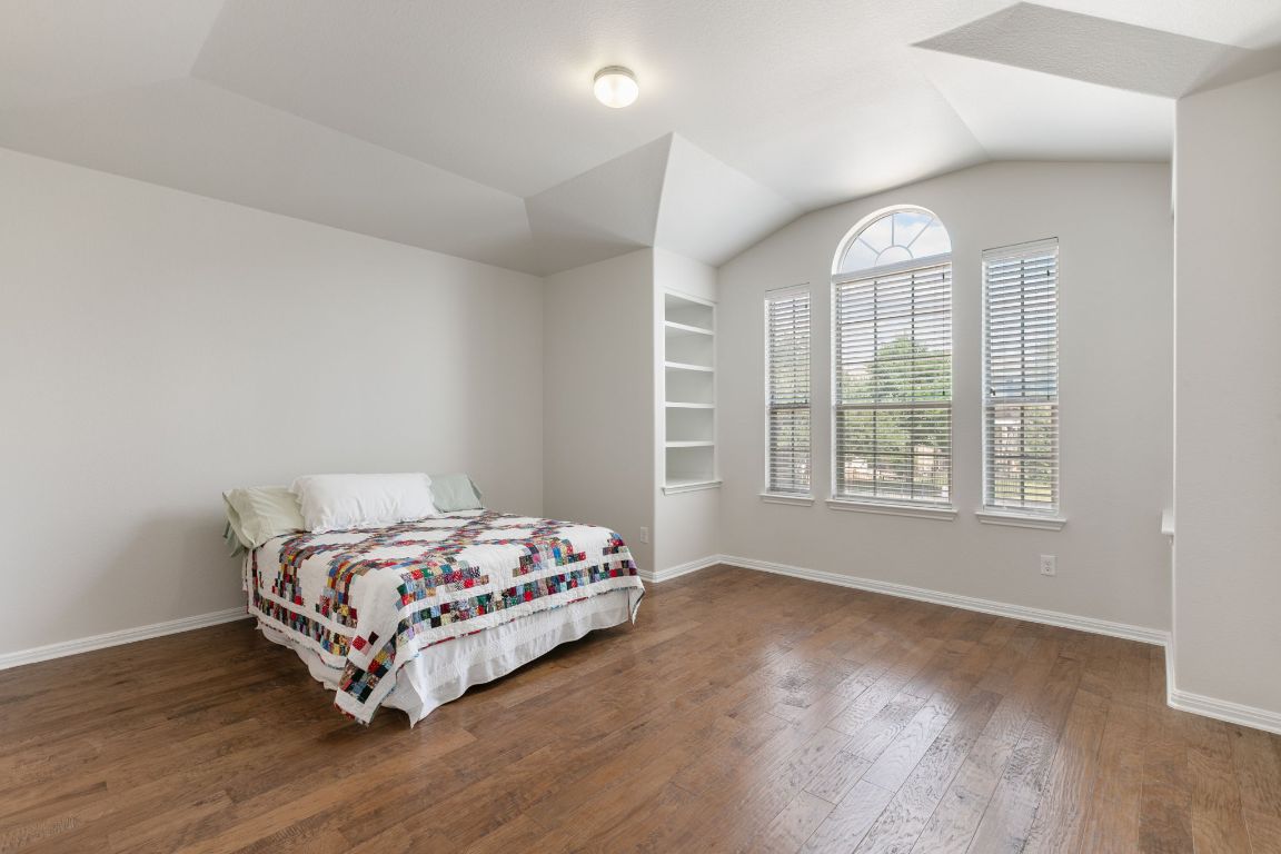 9617 Solana Vista Loop, Unit A Austin, TX 78750 - Photo 25 of 35 a bedroom with a bed and a window