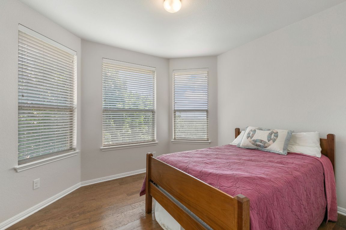 9617 Solana Vista Loop, Unit A Austin, TX 78750 - Photo 27 of 35 a bedroom with a bed and a window