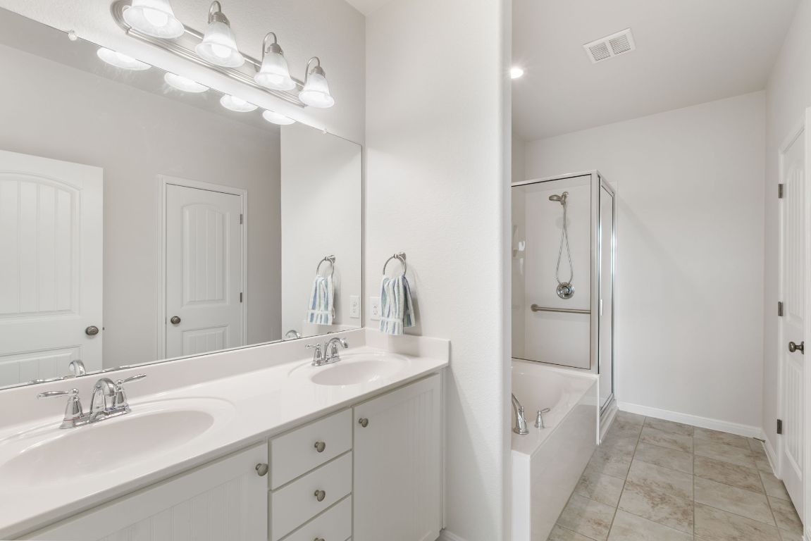 9617 Solana Vista Loop, Unit A Austin, TX 78750 - Photo 29 of 35 a bathroom with a double vanity sink and a mirror