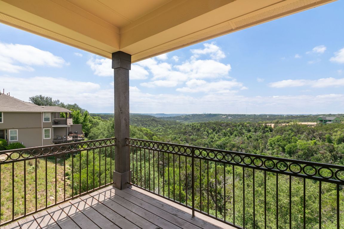 9617 Solana Vista Loop, Unit A Austin, TX 78750 - Photo 3 of 35 a view of a balcony with wooden floor & fence