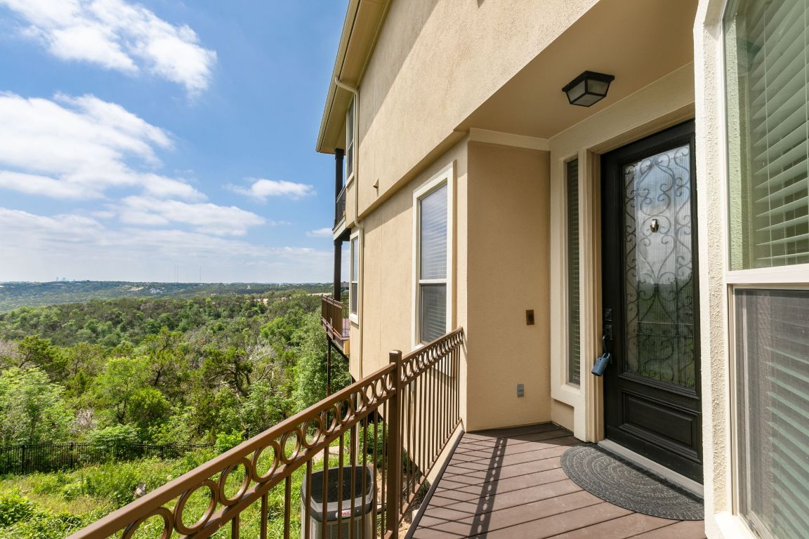 9617 Solana Vista Loop, Unit A Austin, TX 78750 - Photo 32 of 35 a view of a balcony with wooden floor and wooden fence