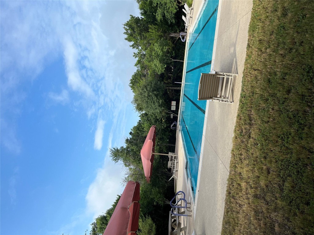9617 Solana Vista Loop, Unit A Austin, TX 78750 - Photo 35 of 35 a swimming pool with an outdoor seating and a garden