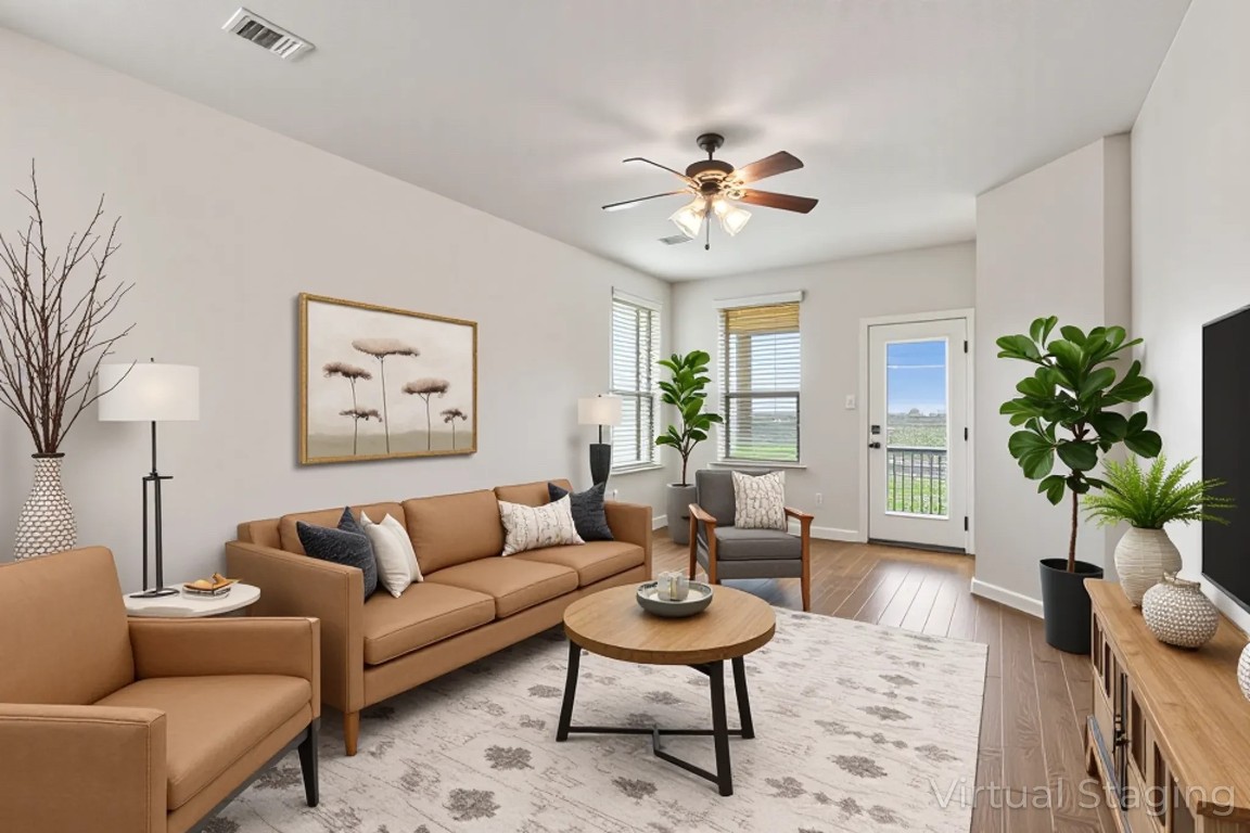 9617 Solana Vista Loop, Unit A Austin, TX 78750 - Photo 10 of 35 a living room with furniture a chandelier and a potted plant