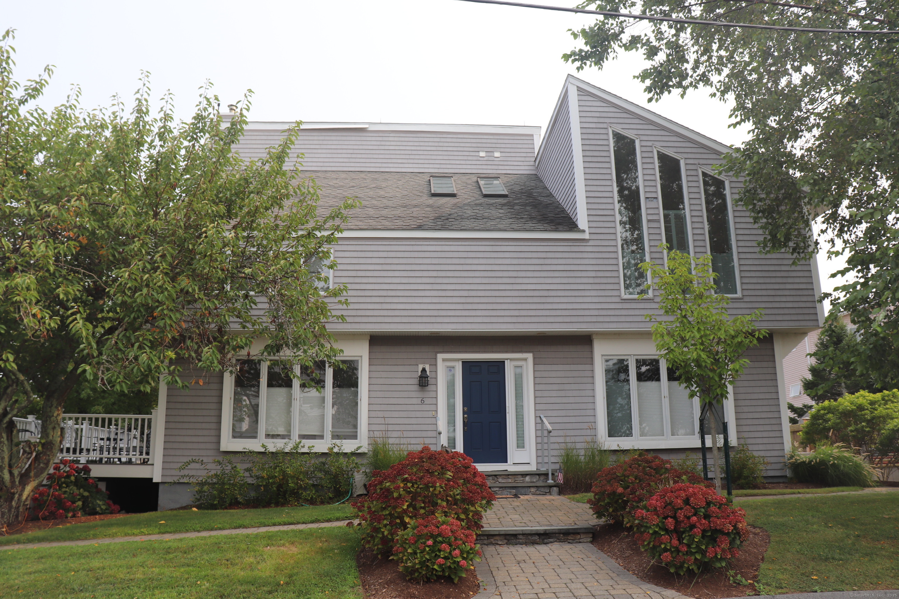6 Leeway Drive Westbrook, CT 06498 - Photo 1 of 1 a front view of a house with a garden and porch