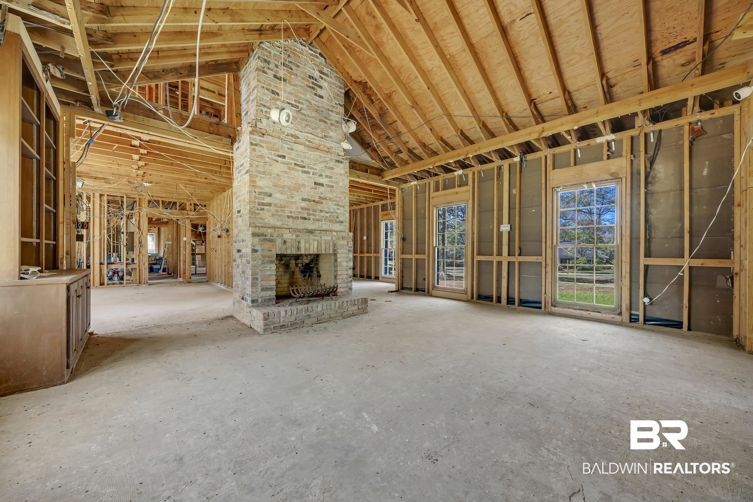 5801 South Fairfax Road Mobile, AL 36608 - Photo 8 of 29 Unfurnished living room featuring a high ceiling and a brick fireplace