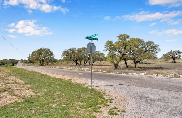 a view of a road with a building in the background
