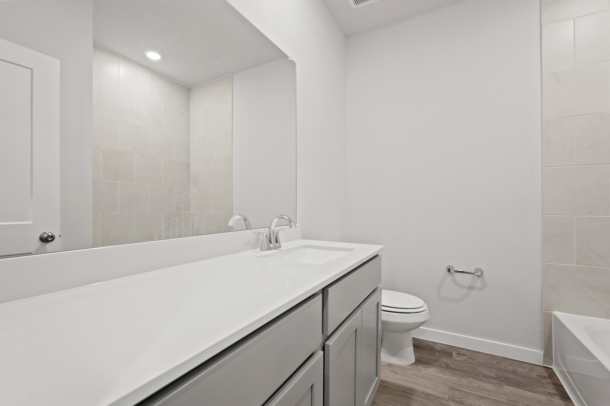112 Water Grass Trail Clute, TX 77531 - Photo 14 of 36 a bathroom with a sink a toilet and vanity