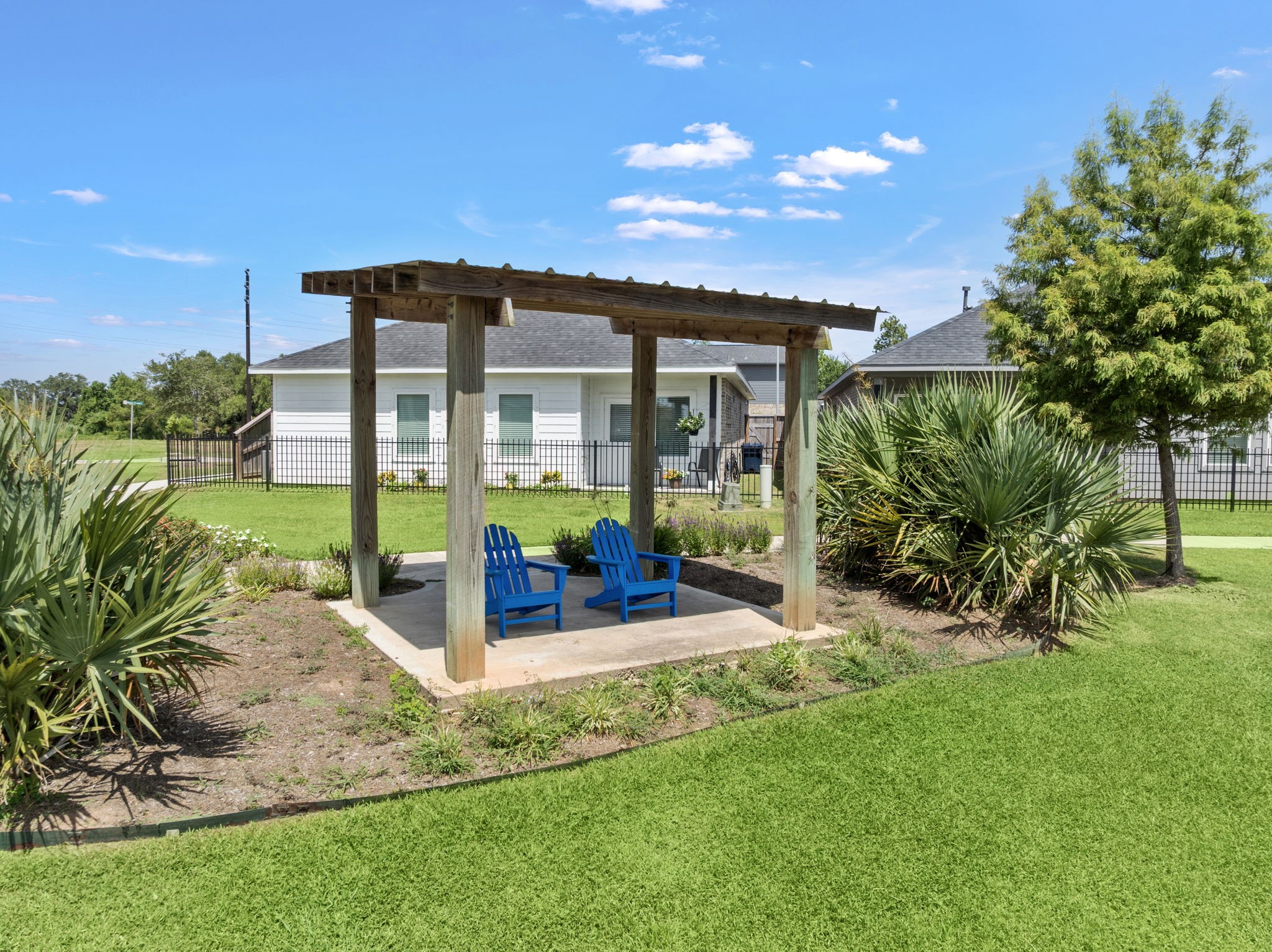 112 Water Grass Trail Clute, TX 77531 - Photo 28 of 36 a view of a patio with a table and chairs under an umbrella