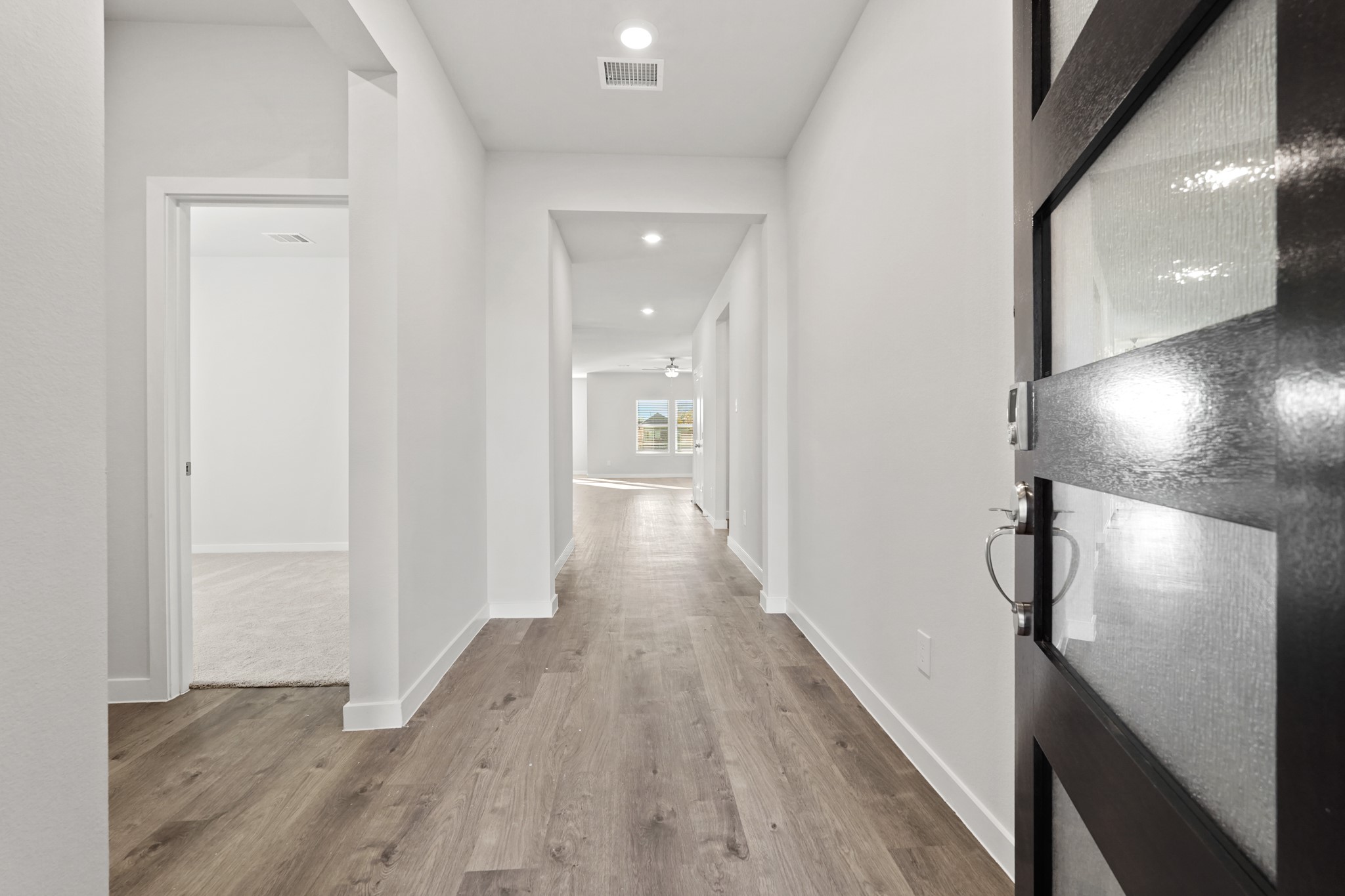 112 Water Grass Trail Clute, TX 77531 - Photo 3 of 36 a view of hallway with wooden floor