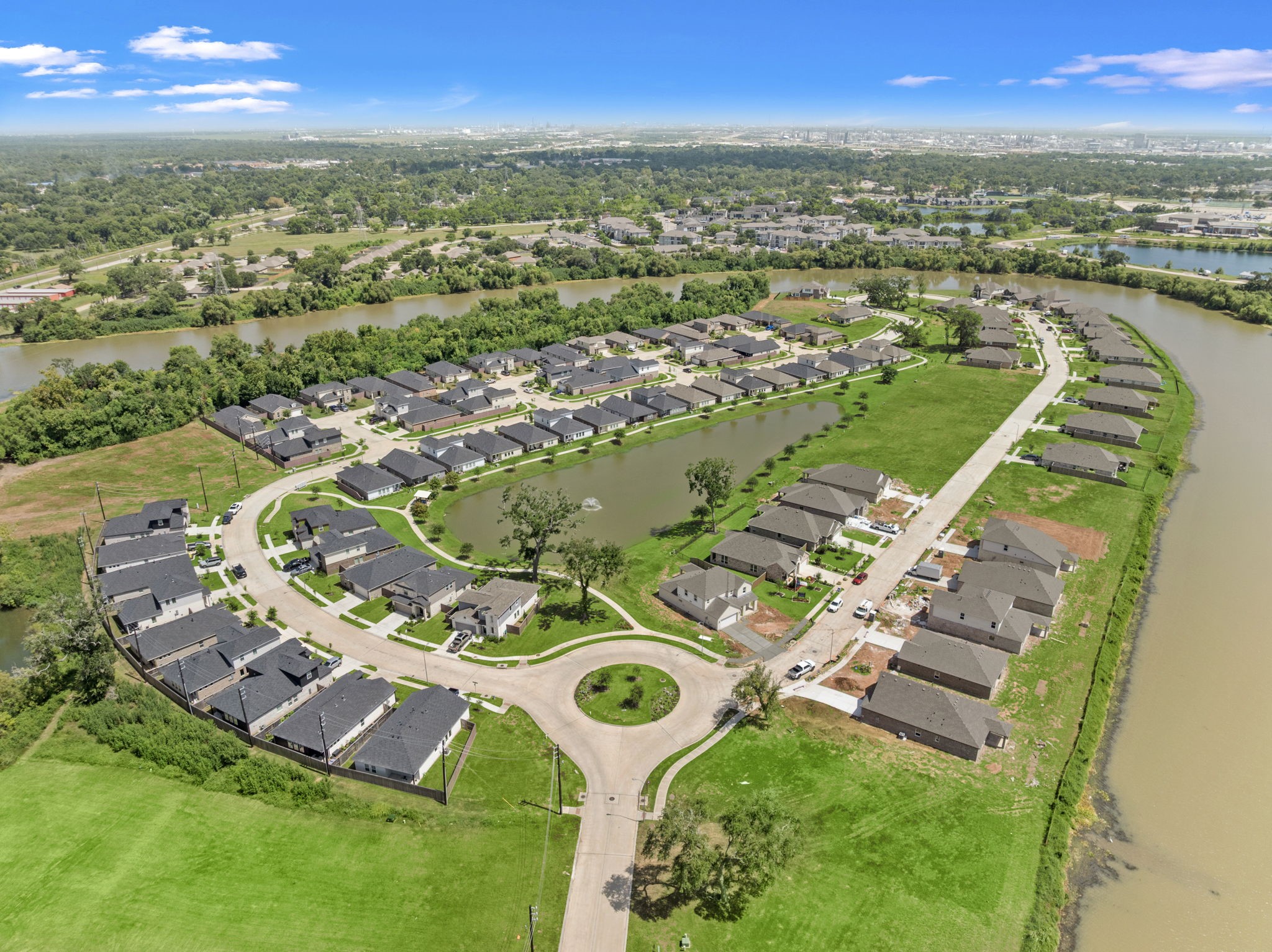 112 Water Grass Trail Clute, TX 77531 - Photo 34 of 36 an aerial view of residential houses with outdoor space and river