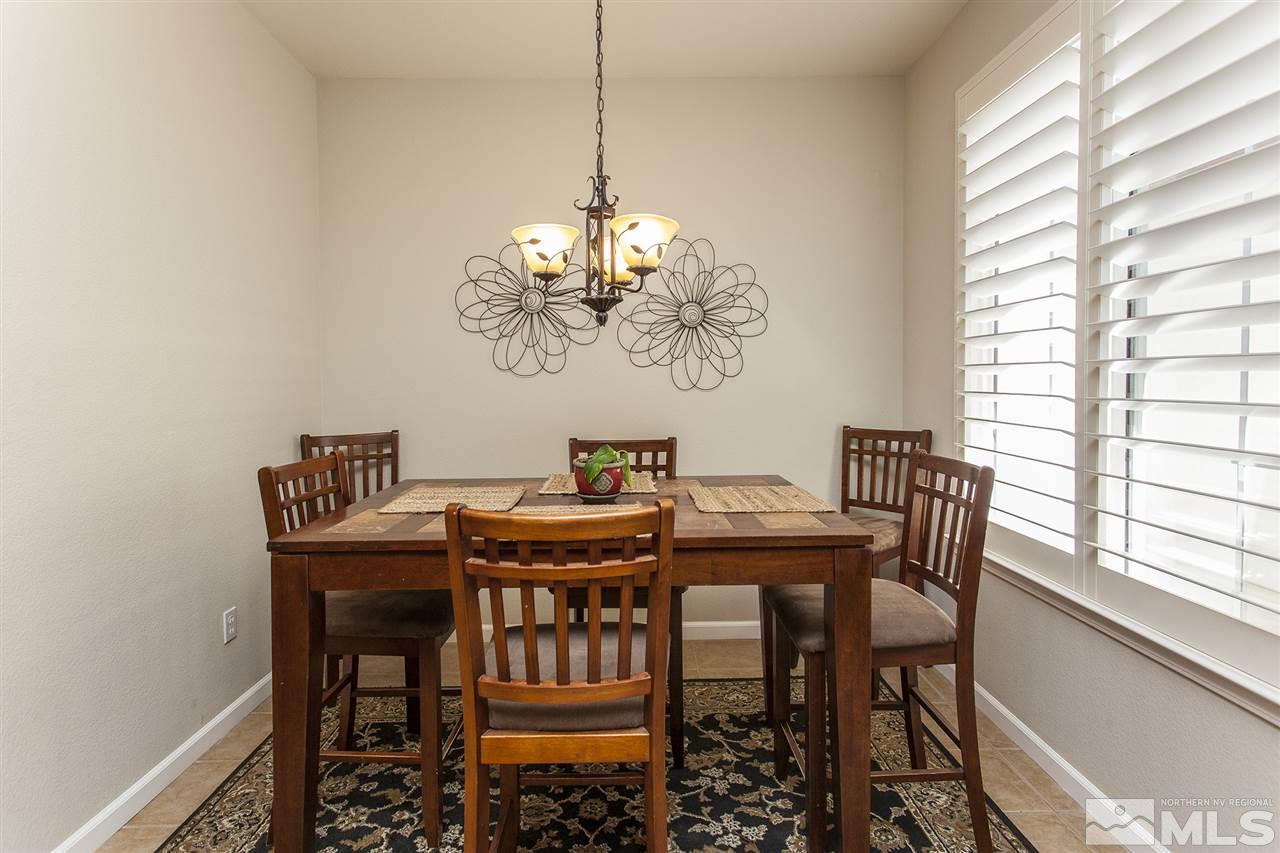 470 Sysonby Court Reno, NV 89521 - Photo 11 of 36 a view of a dining room with furniture a chandelier and wooden floor