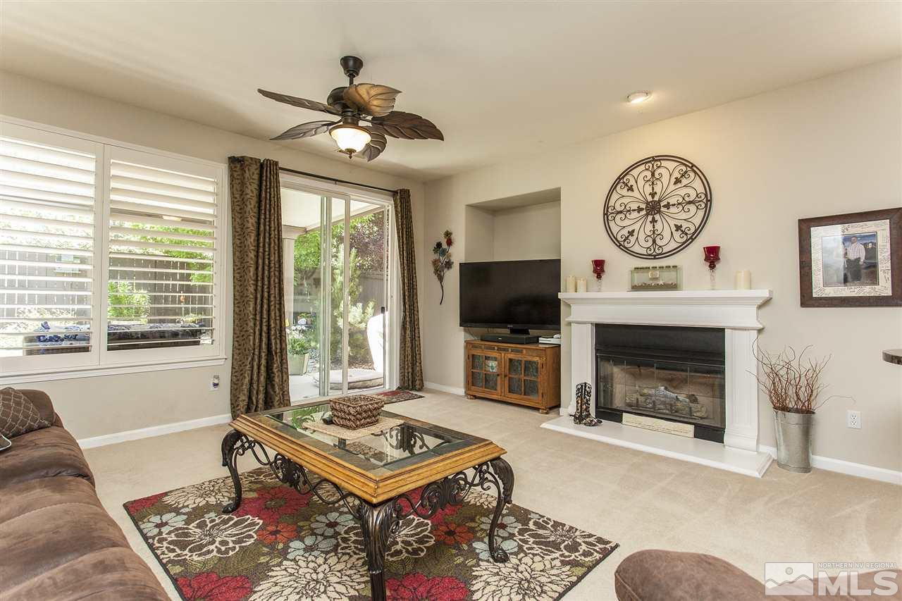 470 Sysonby Court Reno, NV 89521 - Photo 12 of 36 a living room with furniture a fireplace and a flat screen tv