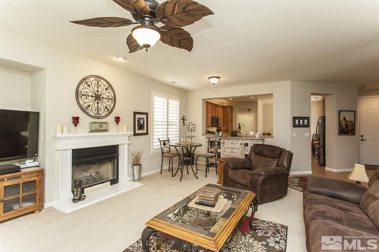 470 Sysonby Court Reno, NV 89521 - Photo 15 of 36 a living room with furniture a fireplace and a flat screen tv