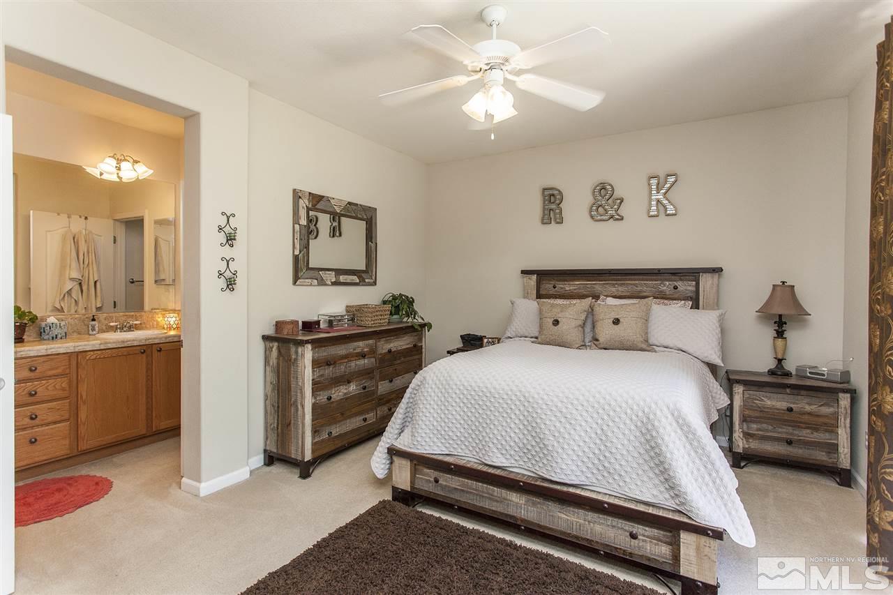 470 Sysonby Court Reno, NV 89521 - Photo 17 of 36 a bedroom with a bed and a chandelier