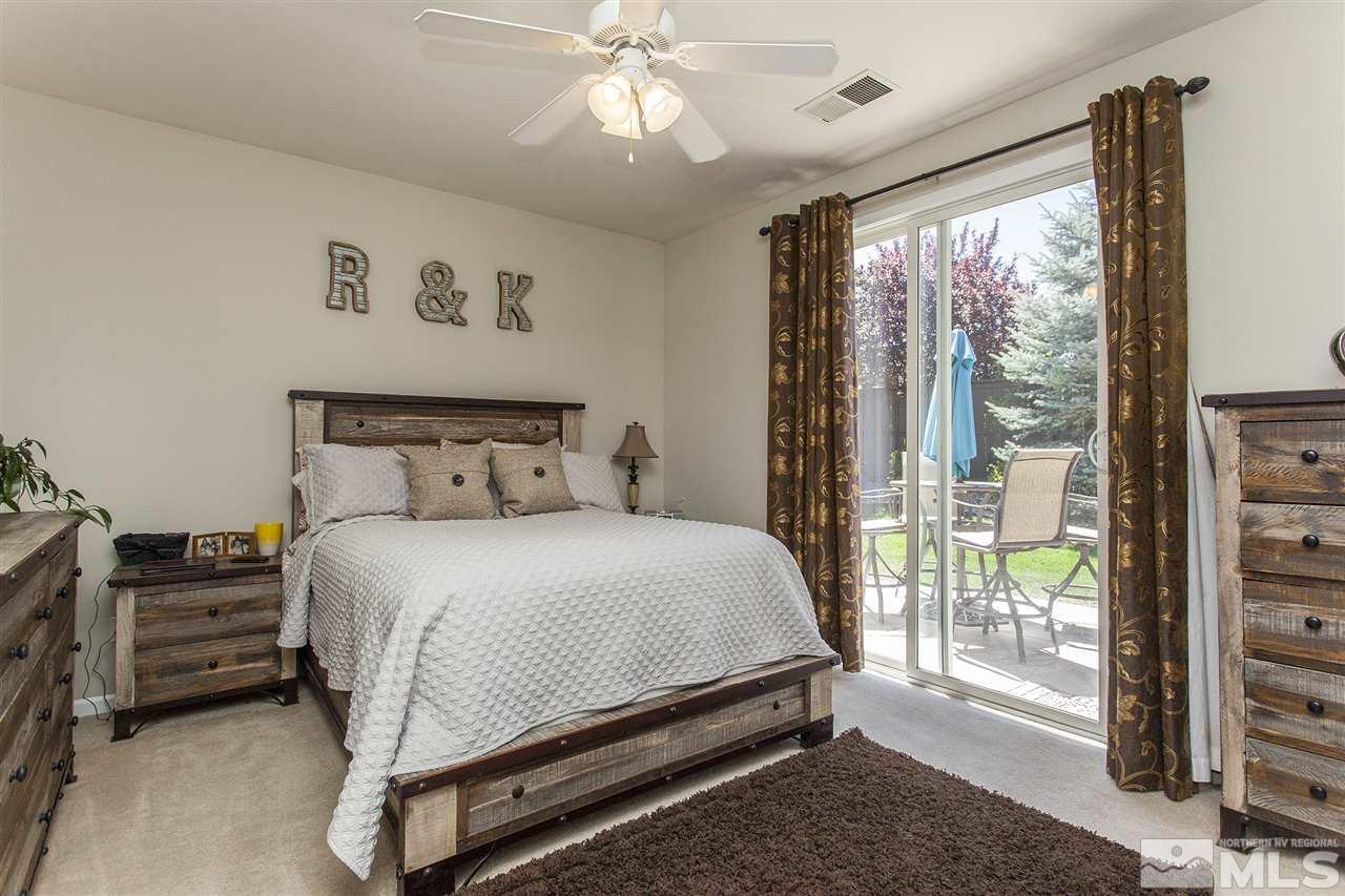 470 Sysonby Court Reno, NV 89521 - Photo 19 of 36 a bedroom with a bed and large window