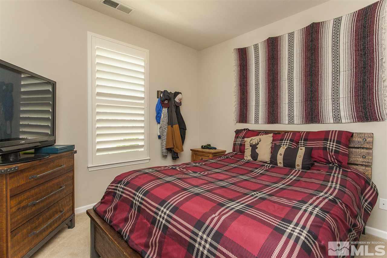 470 Sysonby Court Reno, NV 89521 - Photo 27 of 36 a bedroom with a bed and a flat screen tv