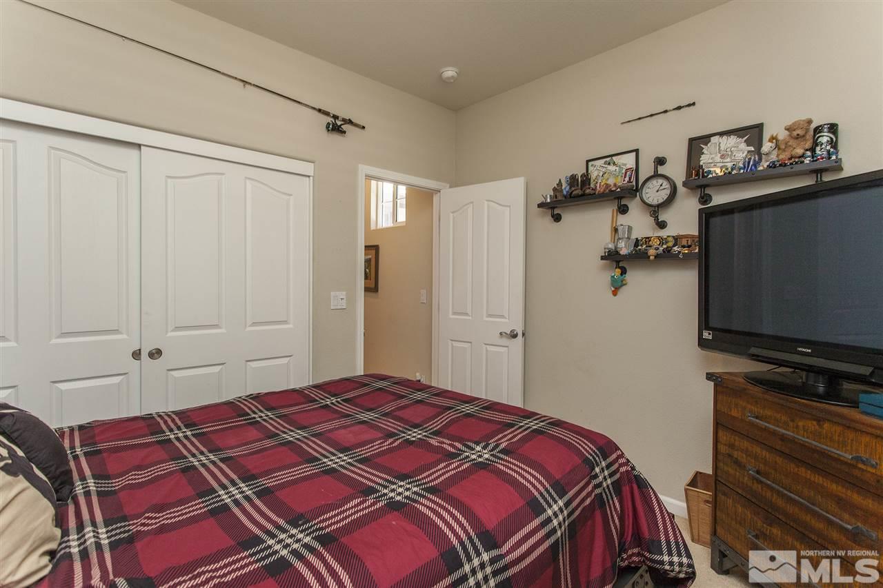 470 Sysonby Court Reno, NV 89521 - Photo 28 of 36 a bedroom with a bed and a flat screen tv