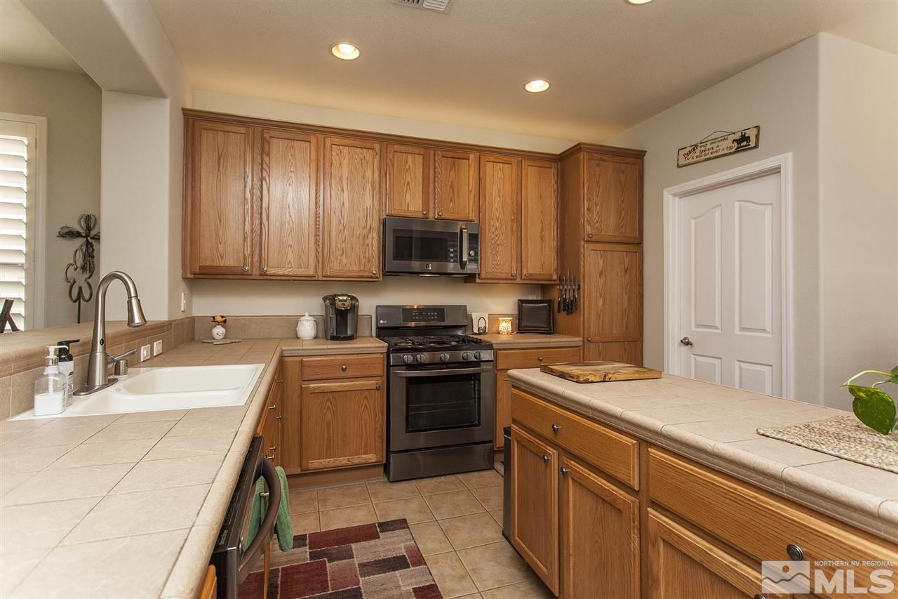 470 Sysonby Court Reno, NV 89521 - Photo 4 of 36 a kitchen with a sink stove and refrigerator