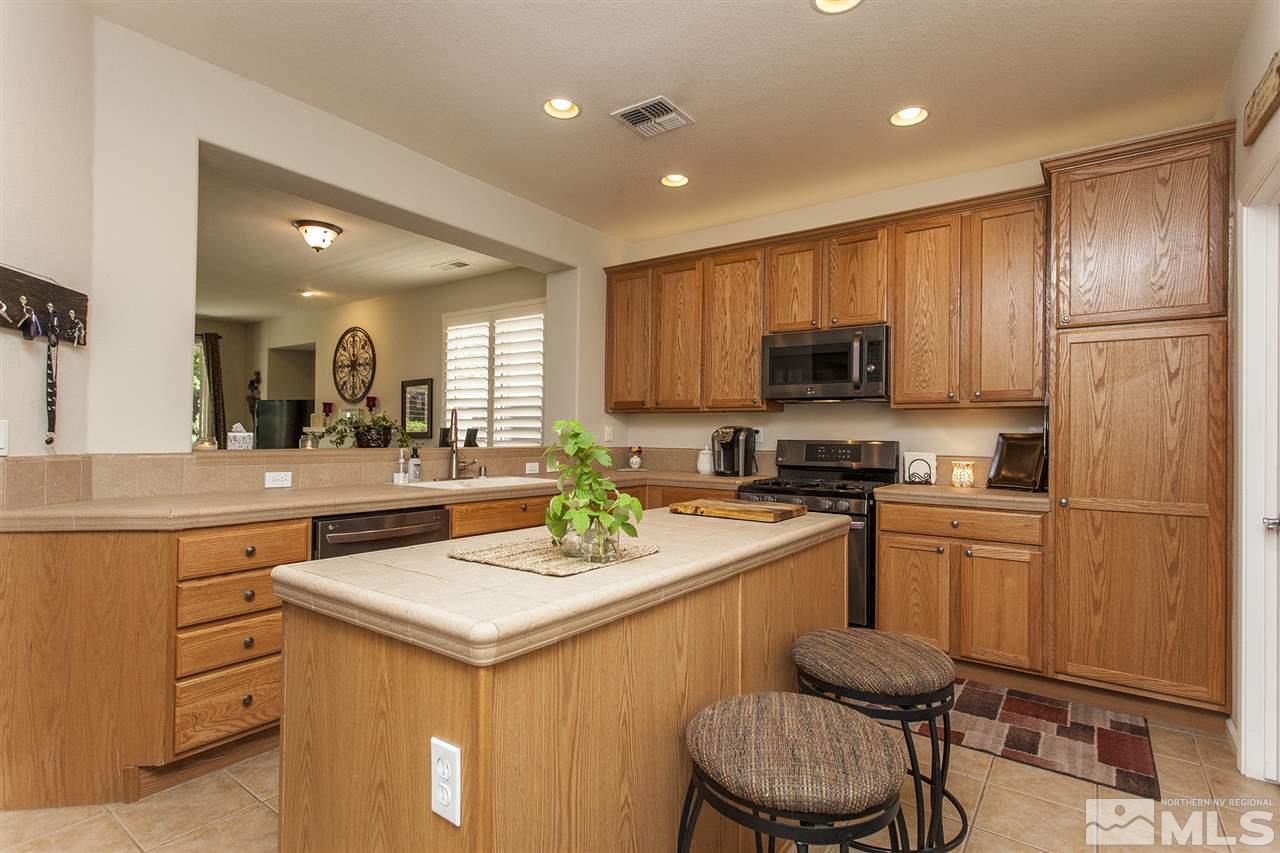 470 Sysonby Court Reno, NV 89521 - Photo 5 of 36 a kitchen with a sink stainless steel appliances and cabinets
