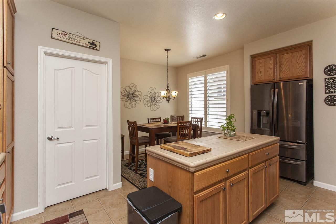 470 Sysonby Court Reno, NV 89521 - Photo 9 of 36 a kitchen with a stove a refrigerator a sink and a dining table