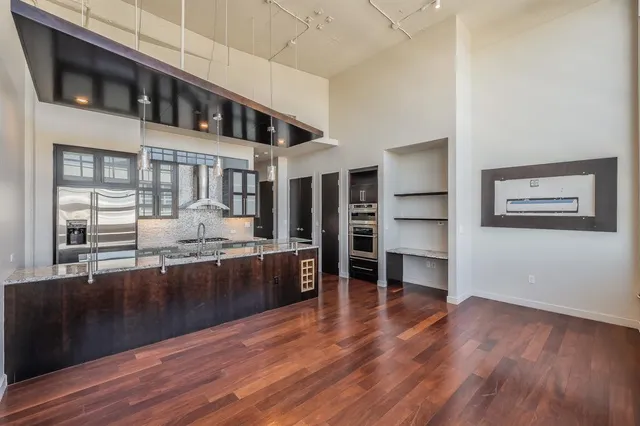 a kitchen with stainless steel appliances granite countertop a stove and a refrigerator