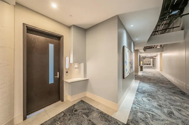 a view of a hallway with windows and closet