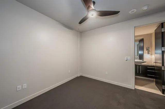 an empty room with a piano and wooden floor
