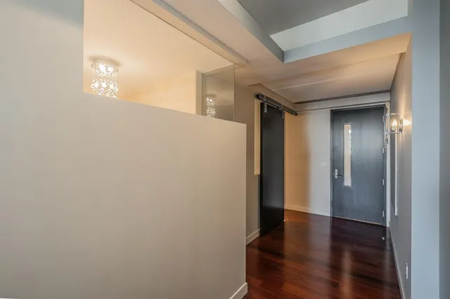 a view of a hallway with wooden floor