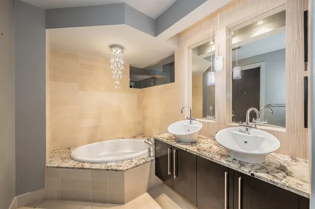 a bathroom with a granite countertop sink a mirror and a toilet
