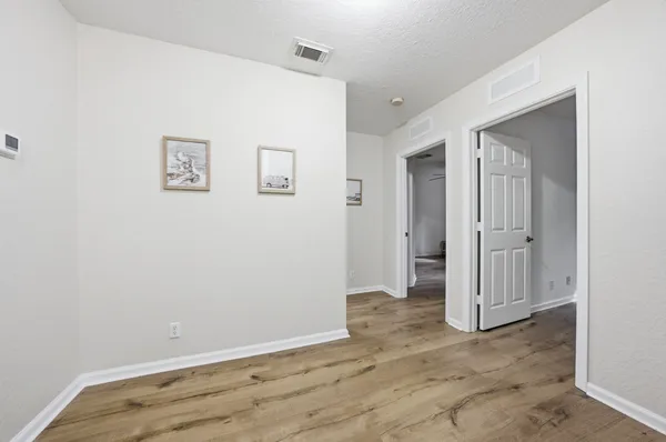 an empty room with wooden floor and closet