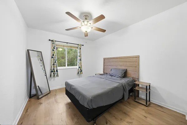 a bedroom with a bed and a window