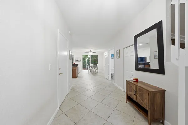 a view of a hallway with wooden shelves
