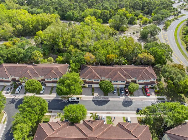 an aerial view of a house with garden space and street view