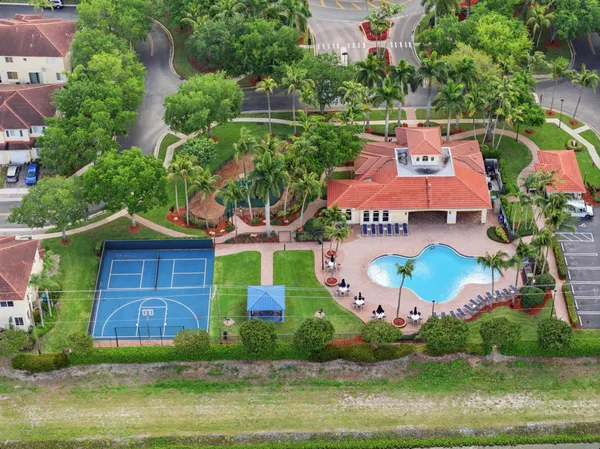 an aerial view of house with yard swimming pool and outdoor seating