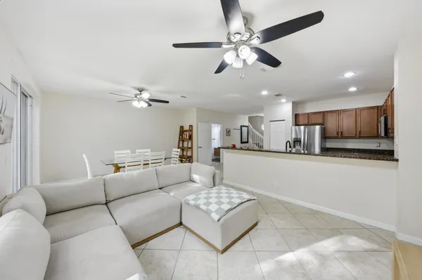 a living room with furniture and kitchen view
