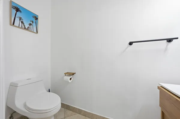 a white toilet sitting next to a shower