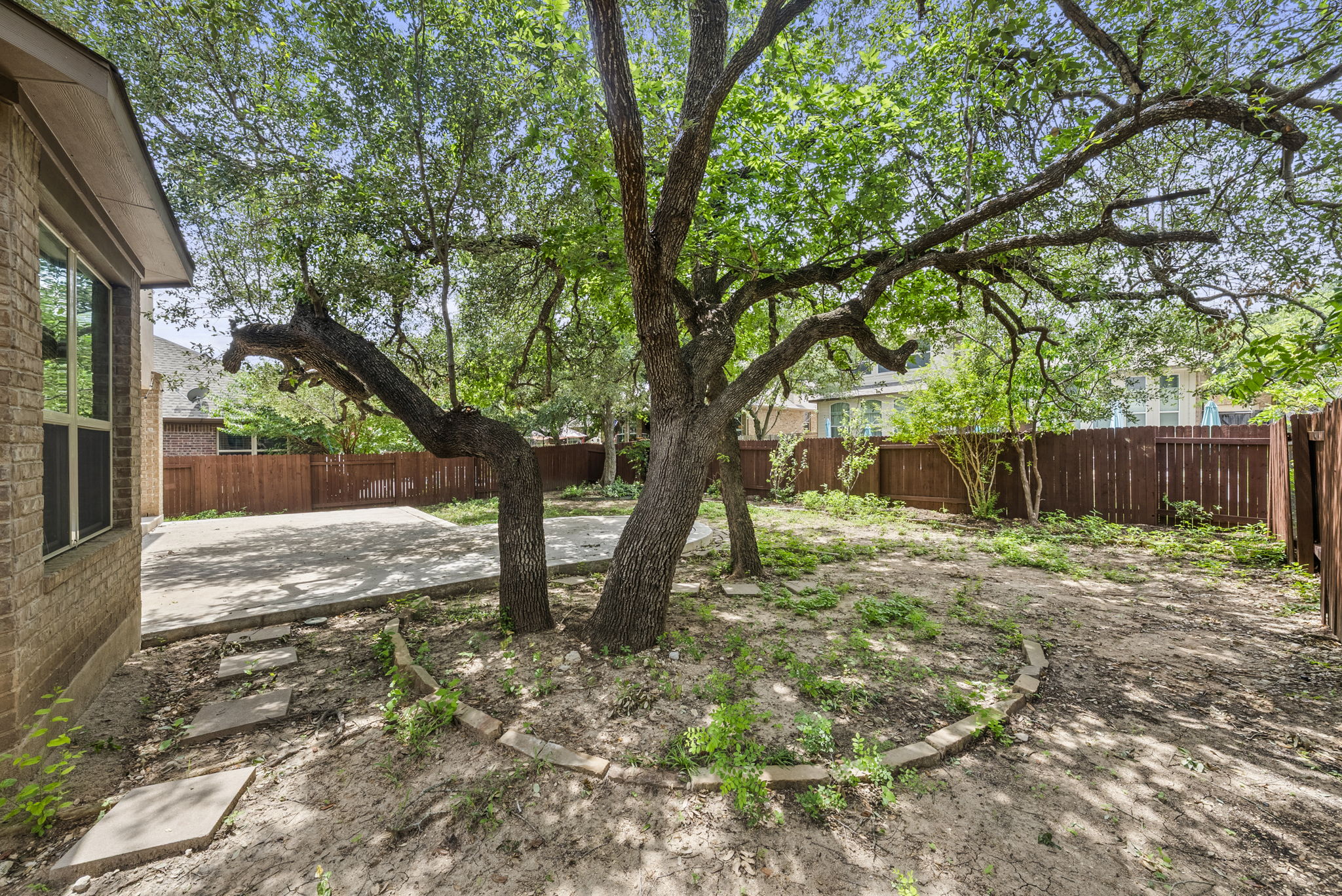 4401 Trinity Woods Street Leander, TX 78641 - Photo 32 of 37 Mature trees offer natural shade and a private setting for this backyard oasis.