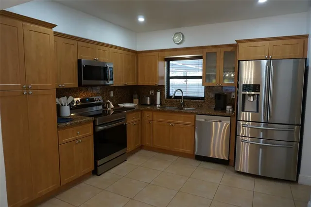 a kitchen with a refrigerator stove and sink