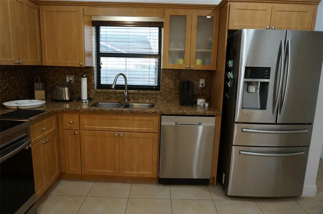 a kitchen with appliances cabinets and a sink