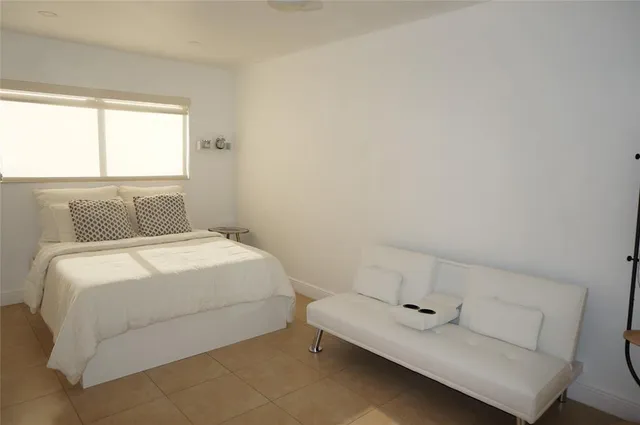 a bedroom with a bed and window