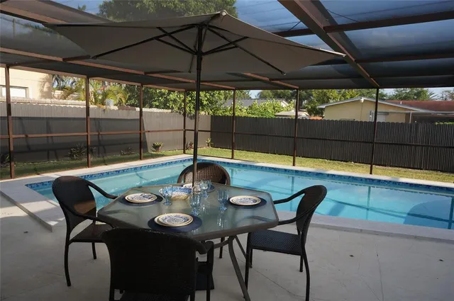 a view of an outdoor dining space with a table and chairs