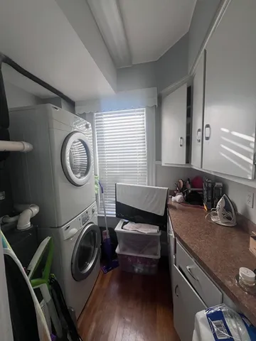 a dining room with wooden floor a chandelier a wooden table and chairs