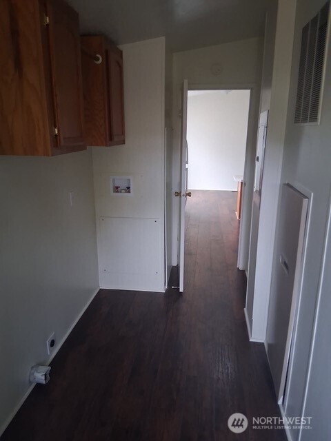 915 Union Mills Road Southeast, Unit 11 Lacey, WA 98503 - Photo 13 of 15 an empty room with wooden floor and a cabinet