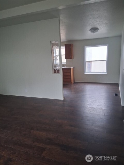 915 Union Mills Road Southeast, Unit 11 Lacey, WA 98503 - Photo 3 of 15 an empty room with wooden floor and windows